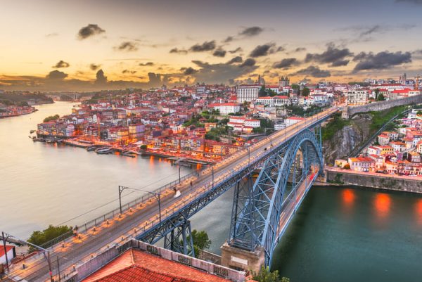 Puente de Oporto Portugal, río y ciudad de fondo al atardecer.